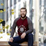 Man Sitting on Brown Wooden Bench